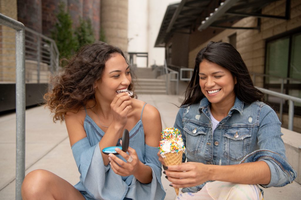 girls eating ice cream with Invisalign clear aligners